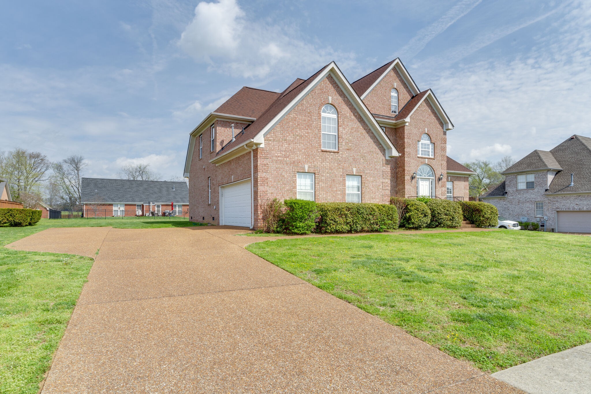 1028 Grider Drive Gallatin, TN 37066 - Photo 3 of 47 a front view of a house with a yard and trees