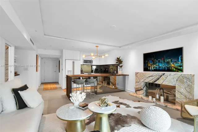 a living room with furniture a dining table and a fireplace