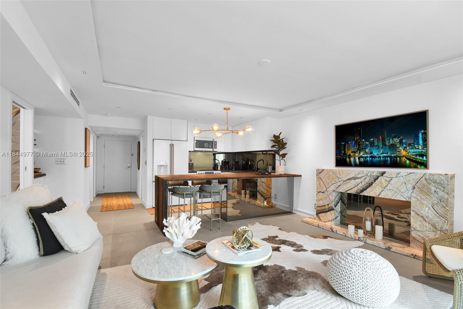 2301 Collins Avenue, Unit 1201 Miami Beach, FL 33139 - Photo 11 of 53 a living room with furniture a dining table and a fireplace