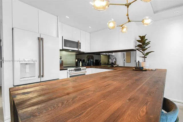 a view of kitchen with furniture and a potted plant