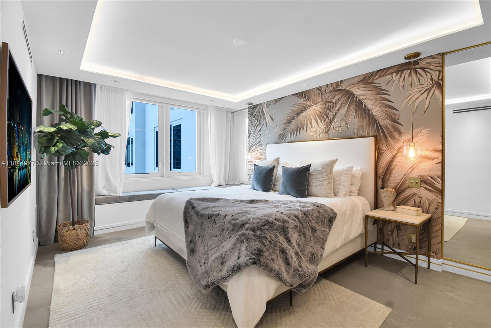 2301 Collins Avenue, Unit 1201 Miami Beach, FL 33139 - Photo 22 of 53 a bedroom with a bed and a potted plant