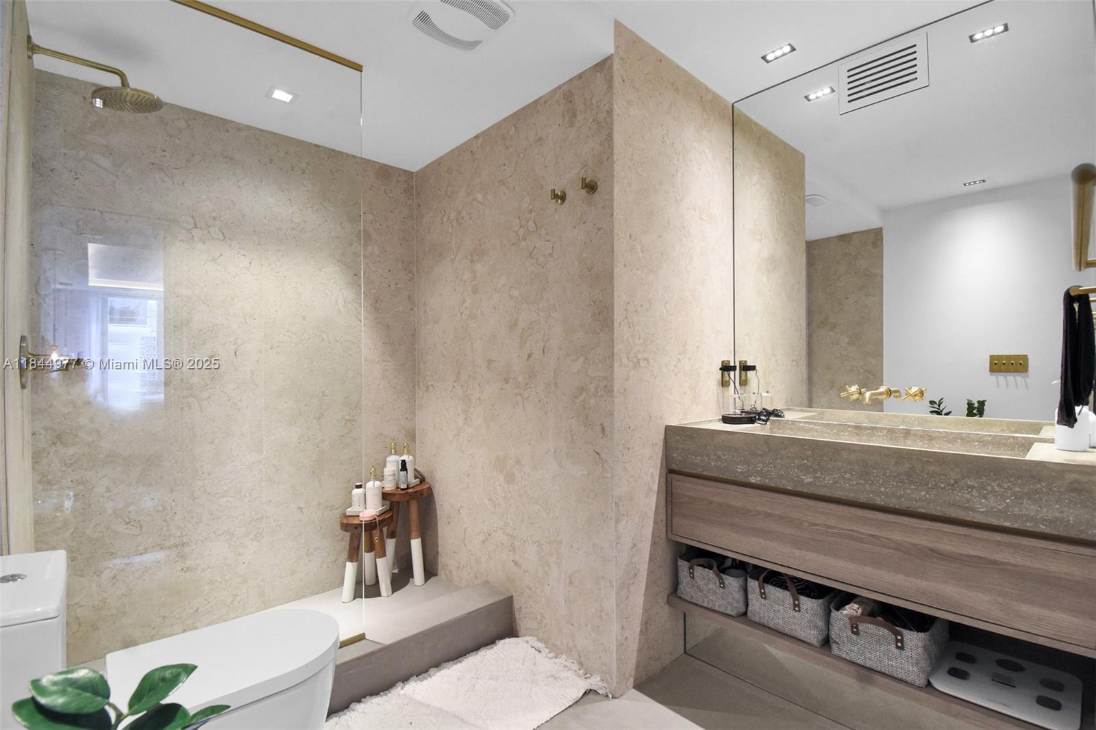 2301 Collins Avenue, Unit 1201 Miami Beach, FL 33139 - Photo 27 of 53 a bathroom with a granite countertop sink a toilet and shower