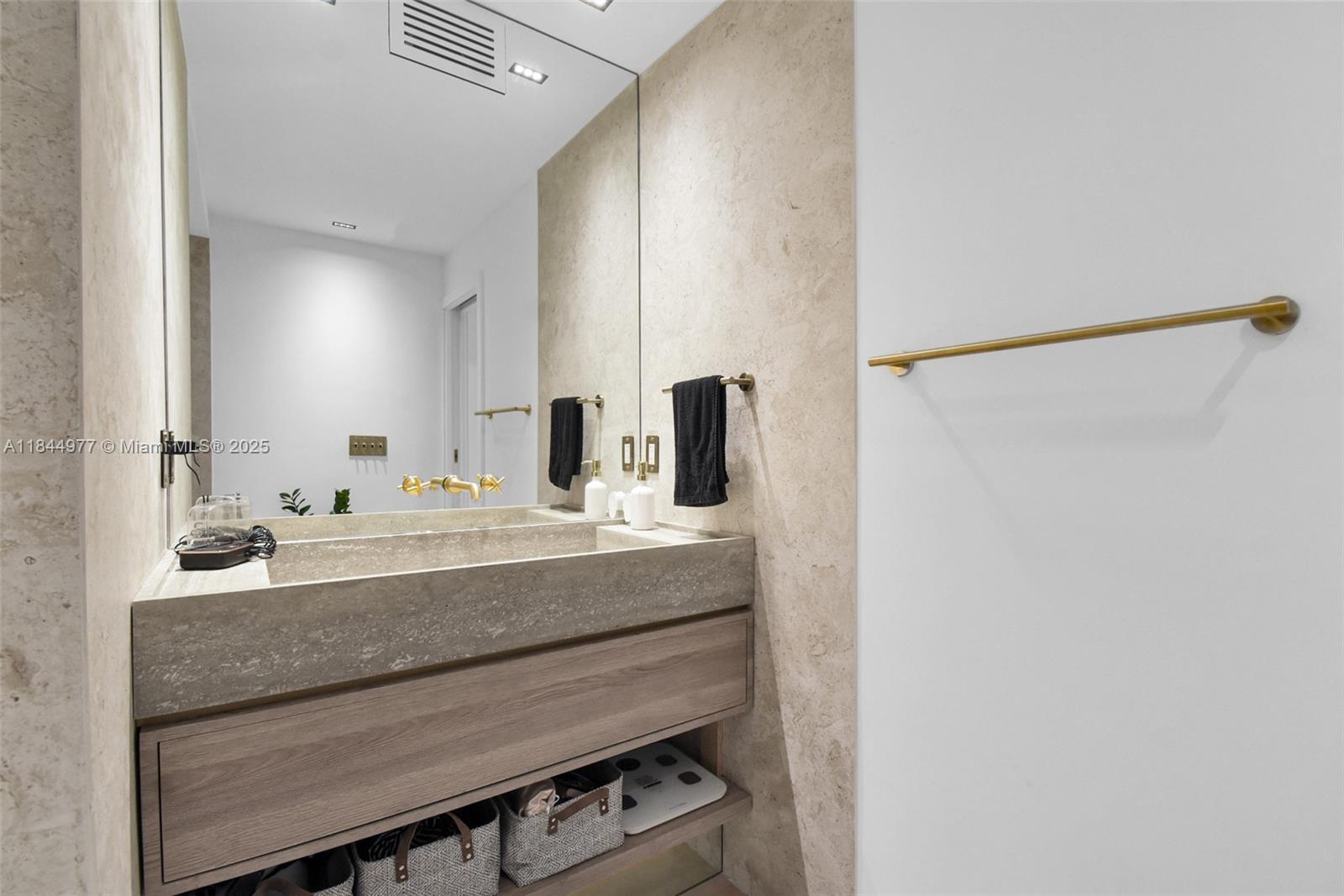 2301 Collins Avenue, Unit 1201 Miami Beach, FL 33139 - Photo 28 of 53 a bathroom with a sink and a mirror