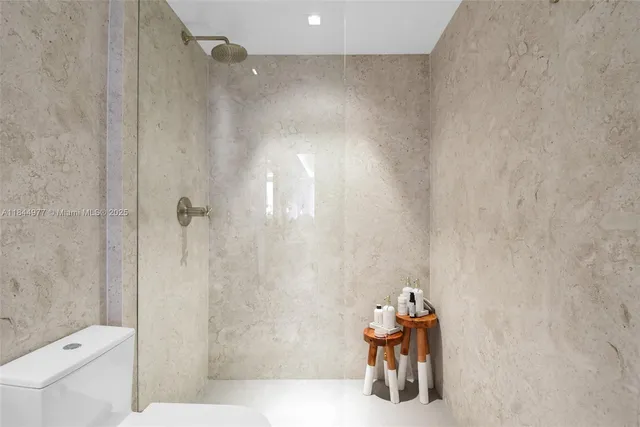 a bathroom with a shower and a toilet