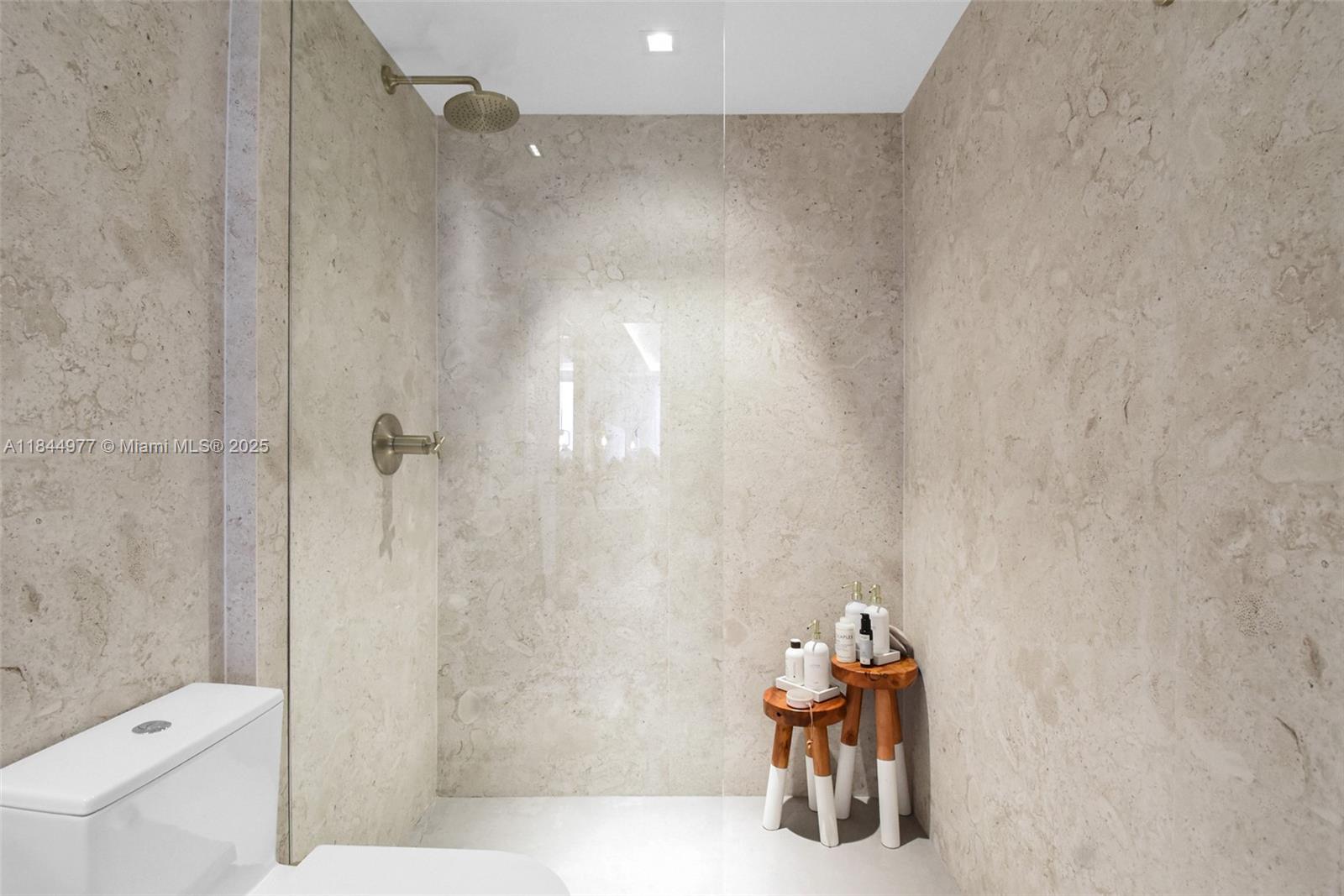 2301 Collins Avenue, Unit 1201 Miami Beach, FL 33139 - Photo 29 of 53 a bathroom with a shower and a toilet