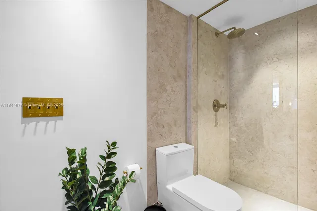 a white toilet sitting next to a bathroom sink