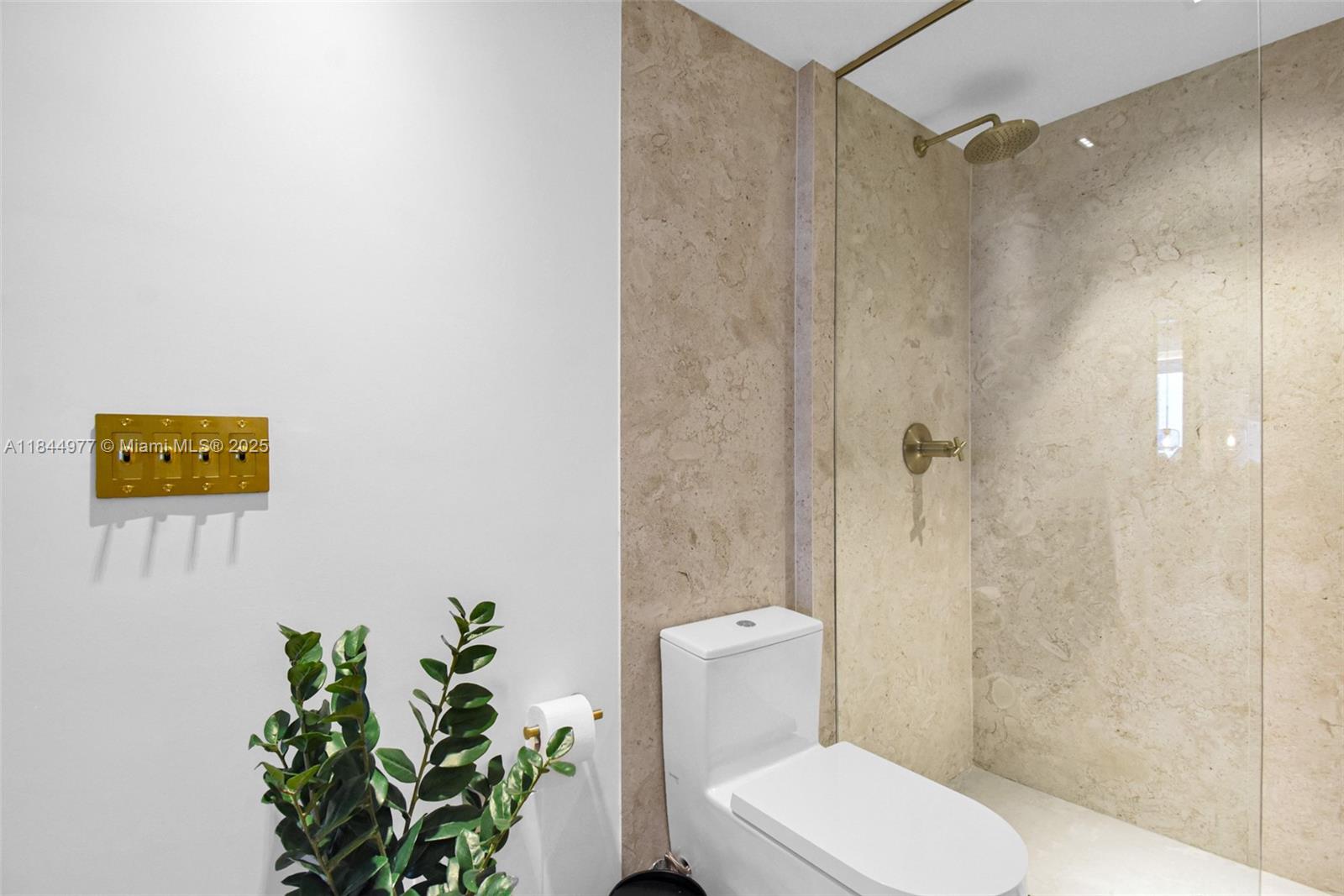 2301 Collins Avenue, Unit 1201 Miami Beach, FL 33139 - Photo 31 of 53 a white toilet sitting next to a bathroom sink