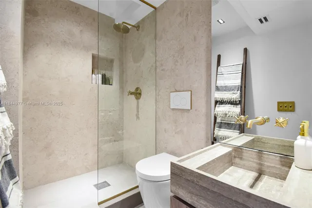 a bathroom with a sink toilet and shower