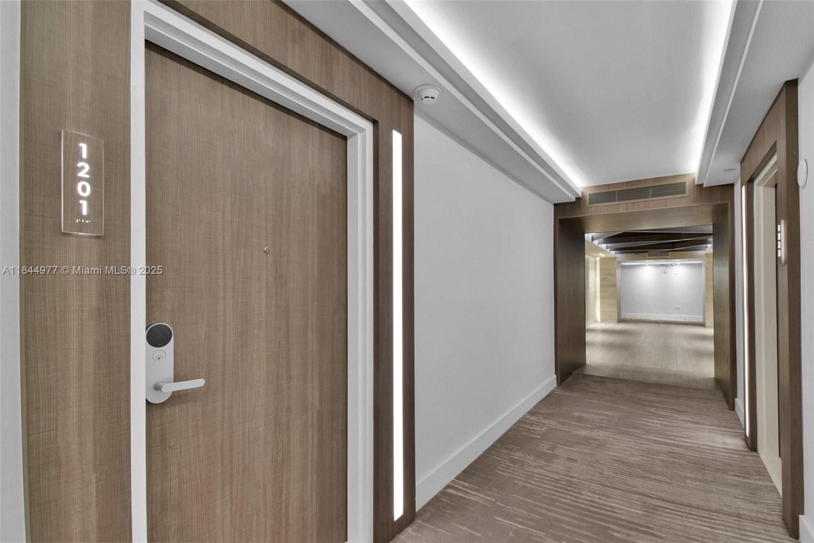 2301 Collins Avenue, Unit 1201 Miami Beach, FL 33139 - Photo 38 of 53 a view of a hallway with wooden floor