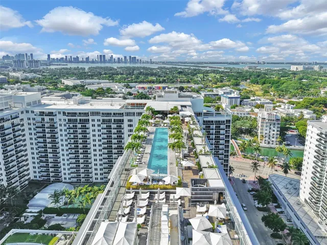 a view of a swimming pool with outdoor seating