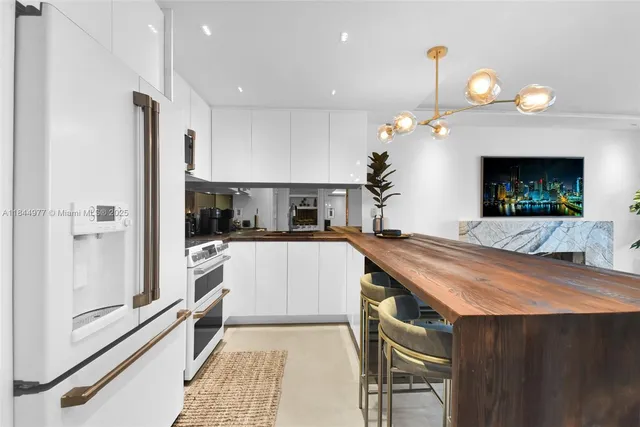 a living room with a table chairs and a fireplace