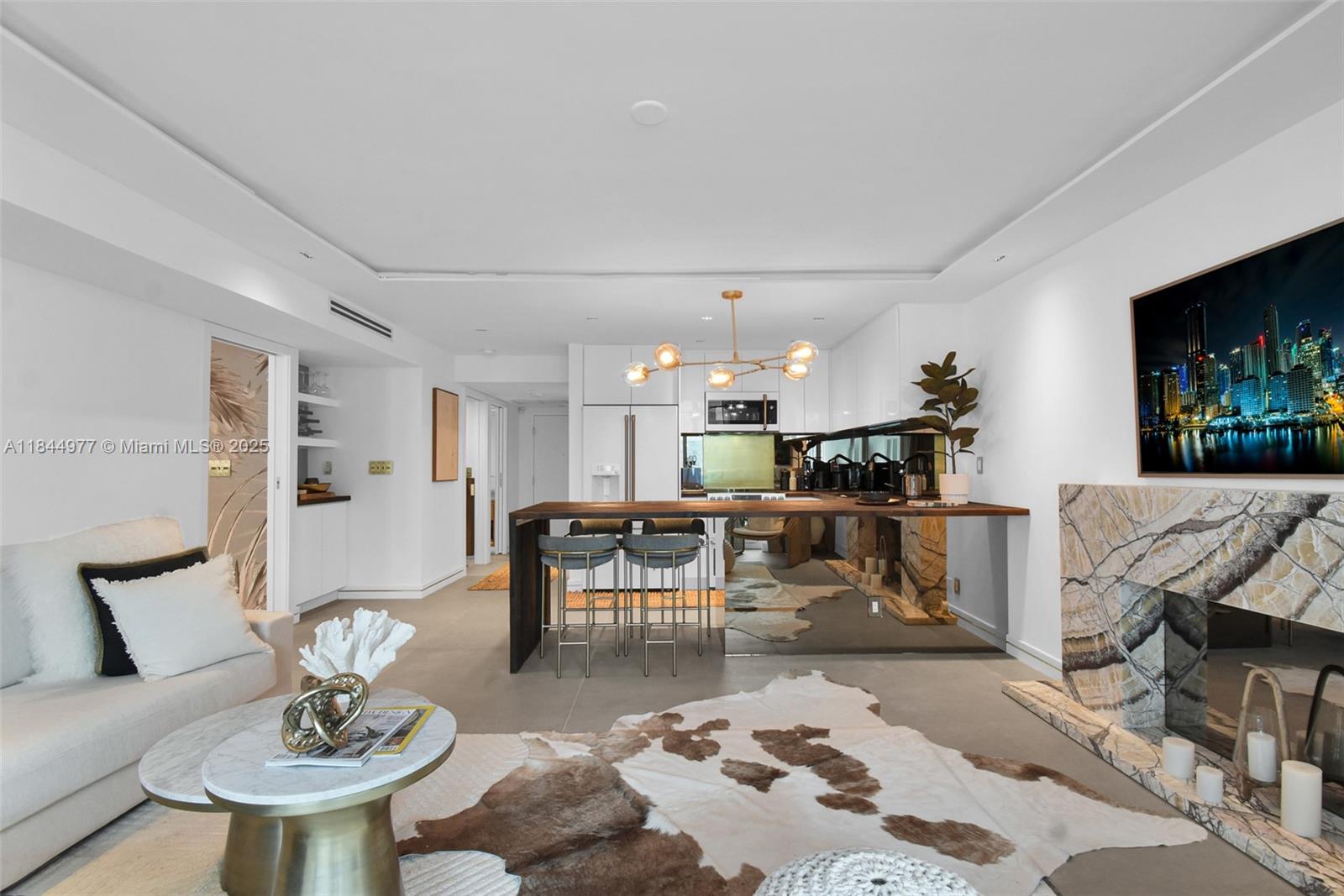 2301 Collins Avenue, Unit 1201 Miami Beach, FL 33139 - Photo 9 of 53 a living room with furniture and a dining room with kitchen view