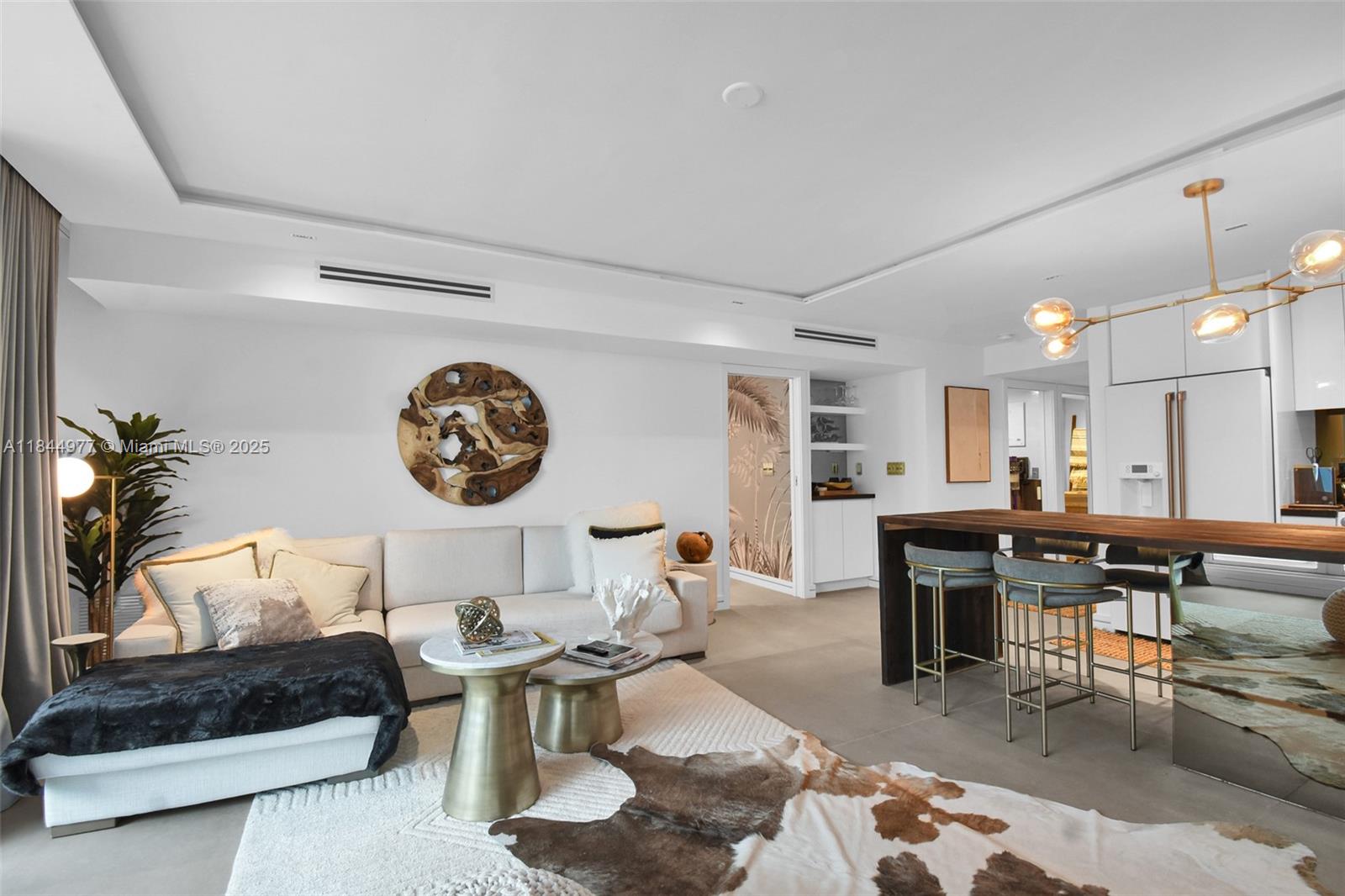 2301 Collins Avenue, Unit 1201 Miami Beach, FL 33139 - Photo 10 of 53 a living room with furniture a table and kitchen view