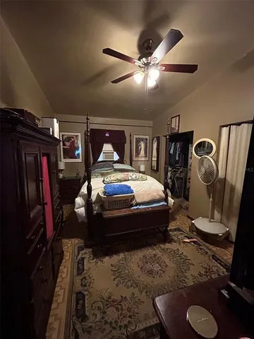a bedroom with bed and a mirror