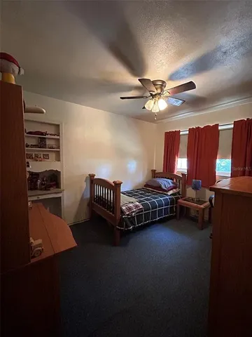 a room with furniture and a ceiling fan