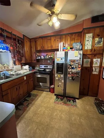a kitchen with stainless steel appliances granite countertop a stove refrigerator and cabinets
