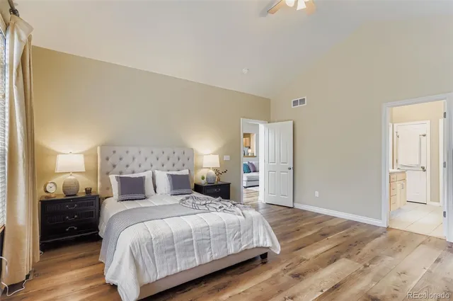 a bedroom with a bed and wooden floor