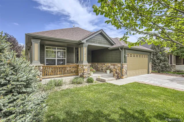 a front view of a house with patio and garden