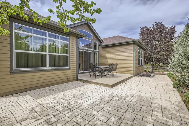 a view of a house with backyard and a tree