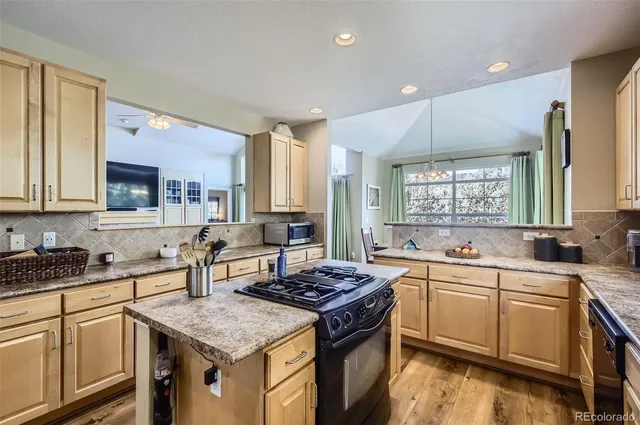 a kitchen with a sink stove top oven and cabinets