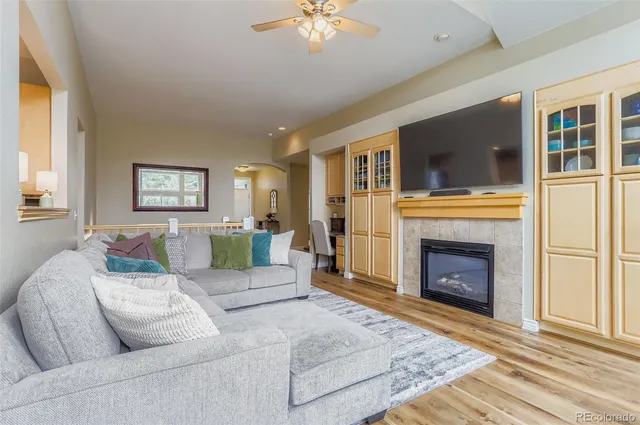 a living room with furniture a fireplace and a flat screen tv