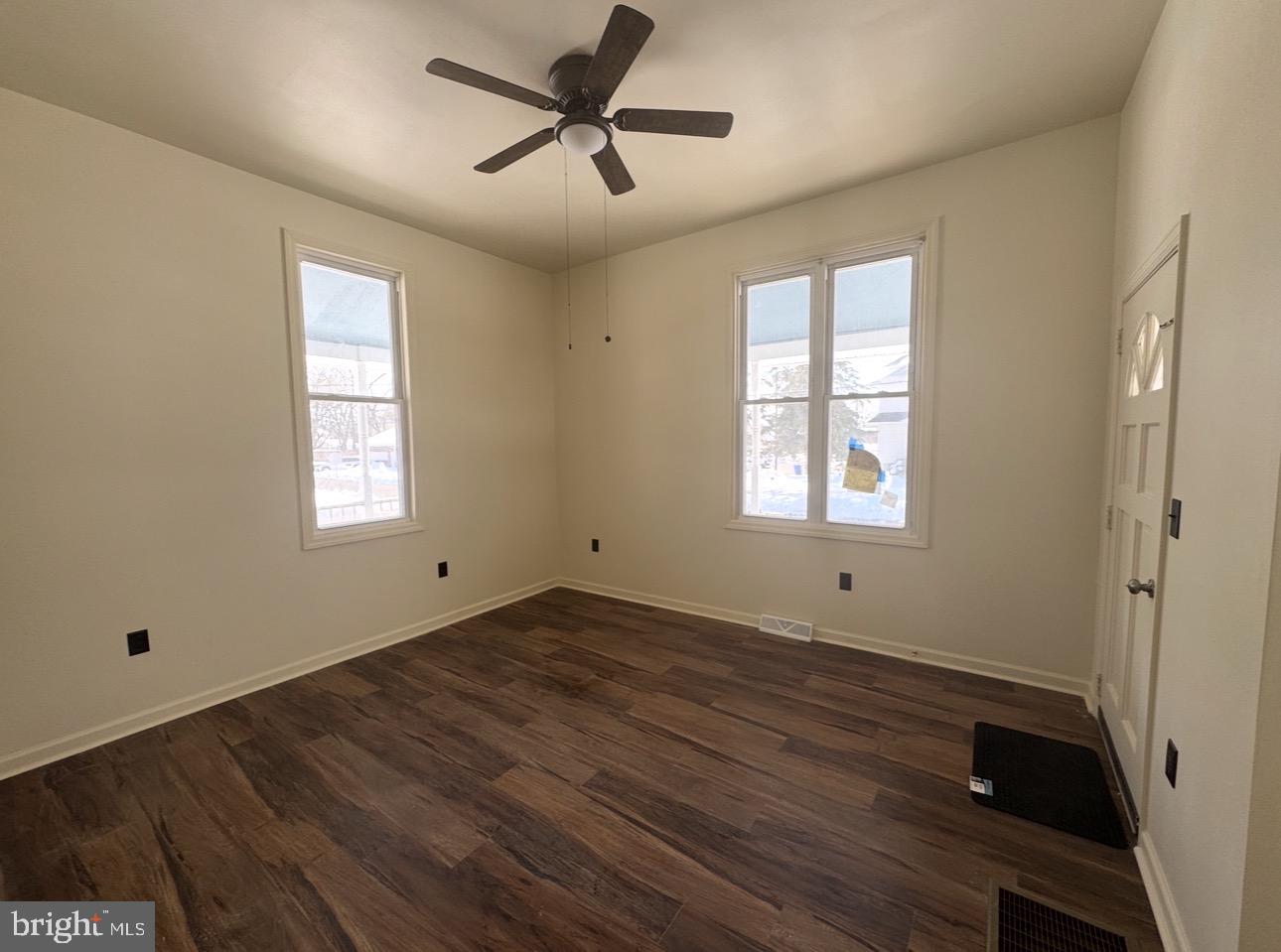 126 Washington Avenue, Unit 1A Laurel Springs, NJ 08021 - Photo 3 of 9 a view of empty room with wooden floor and fan