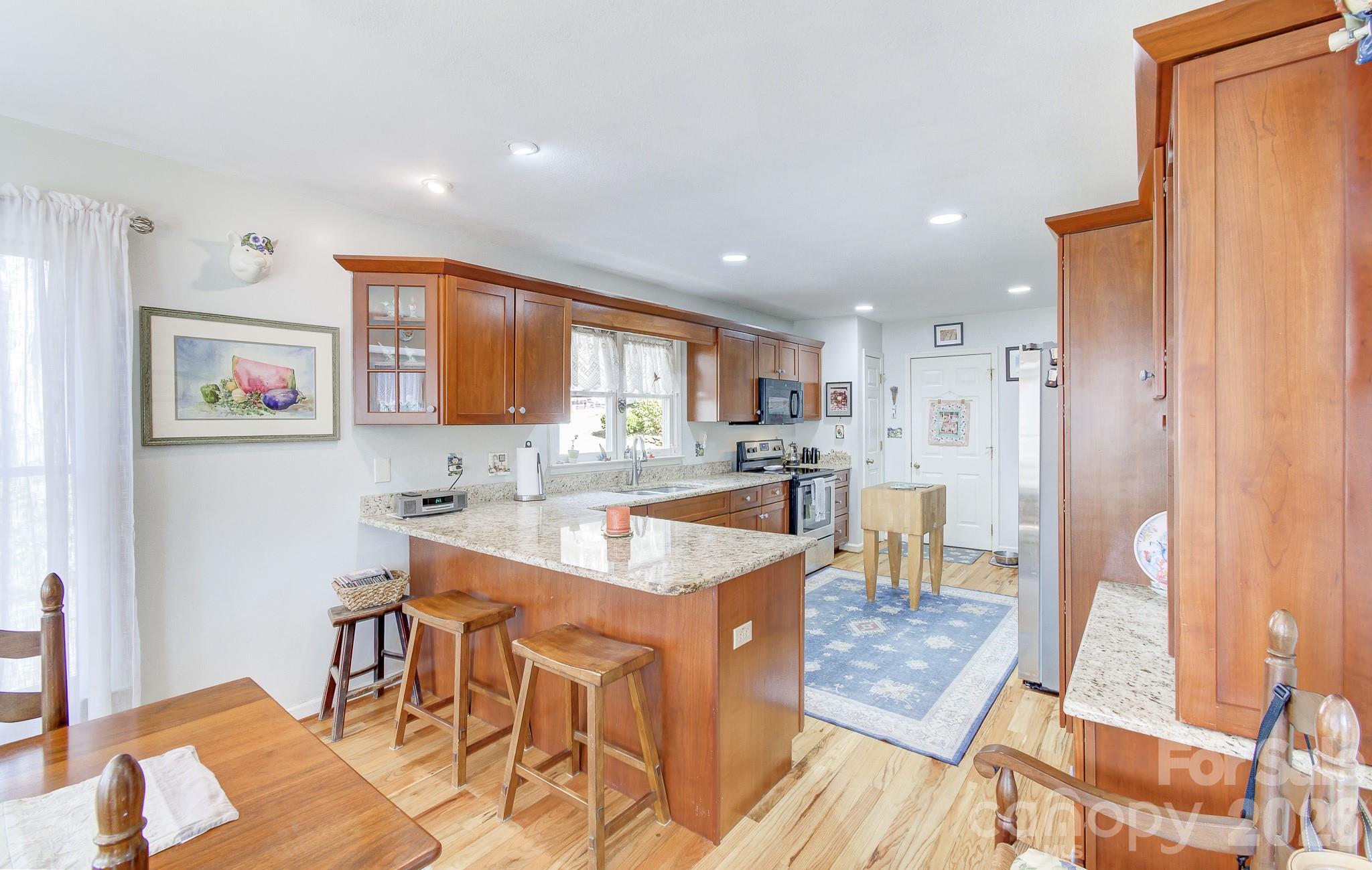737 Woodbine Road Waynesville, NC 28785 - Photo 15 of 48 a large kitchen with a table and chairs in it