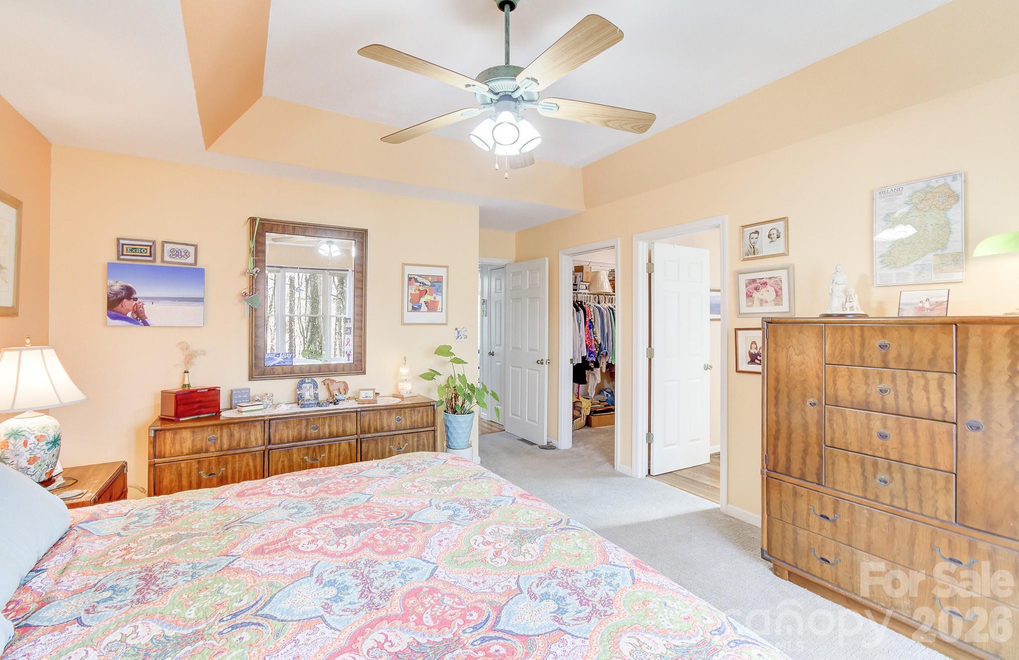 737 Woodbine Road Waynesville, NC 28785 - Photo 25 of 48 a bedroom with a bed and a chandelier
