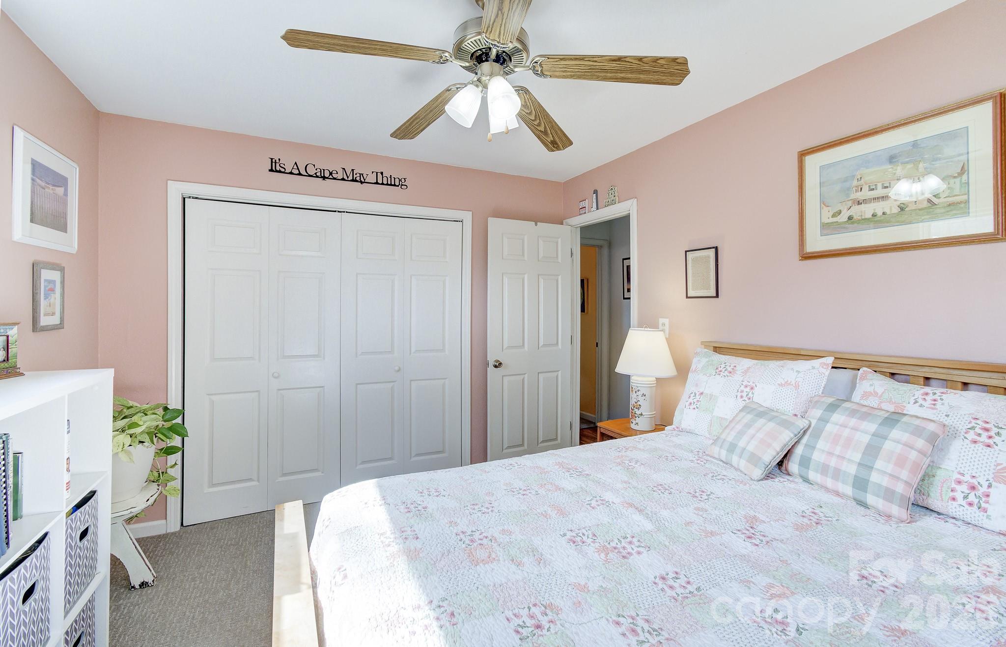 737 Woodbine Road Waynesville, NC 28785 - Photo 34 of 48 a bedroom with a bed and a chandelier