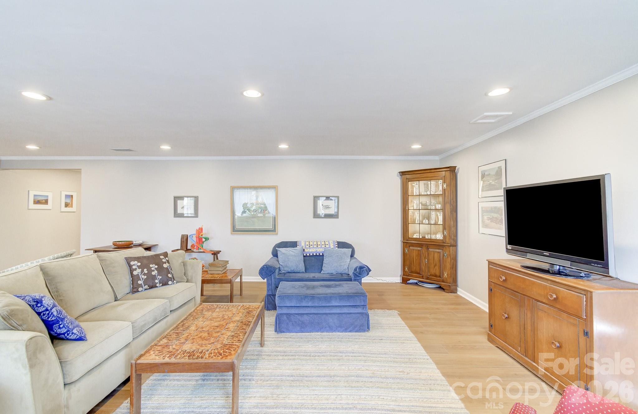 737 Woodbine Road Waynesville, NC 28785 - Photo 38 of 48 a living room with furniture and a flat screen tv