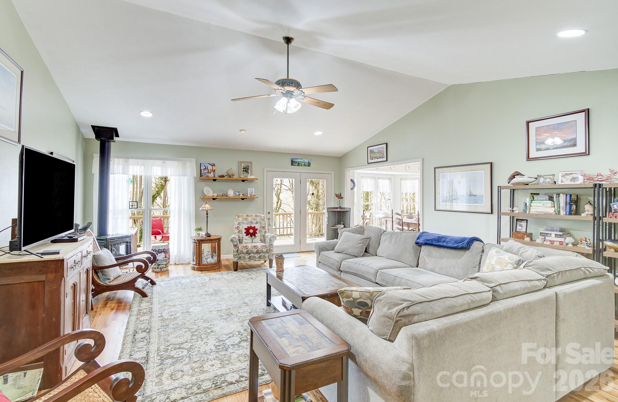 737 Woodbine Road Waynesville, NC 28785 - Photo 5 of 48 a living room with furniture and a flat screen tv