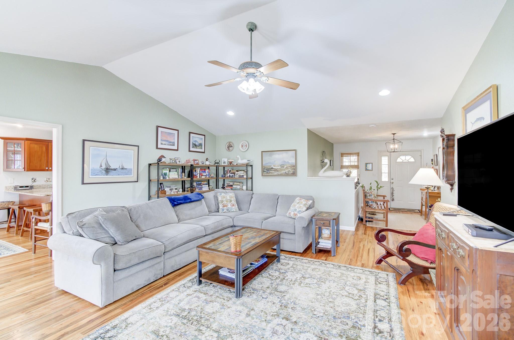 737 Woodbine Road Waynesville, NC 28785 - Photo 7 of 48 a living room with furniture a ceiling fan and a flat screen tv