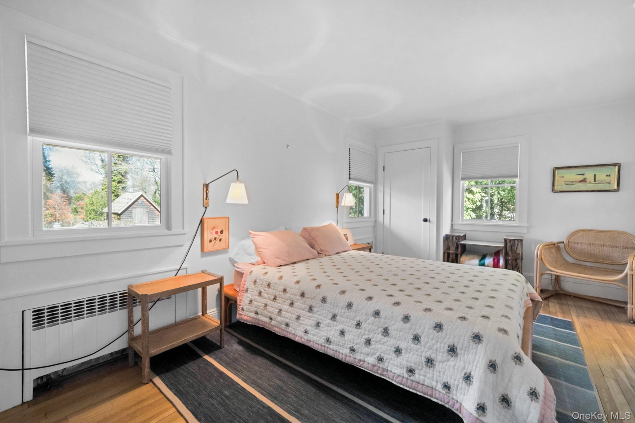 36 South Howells Point Road Bellport, NY 11713 - Photo 14 of 29 a bedroom with a bed and wooden floor