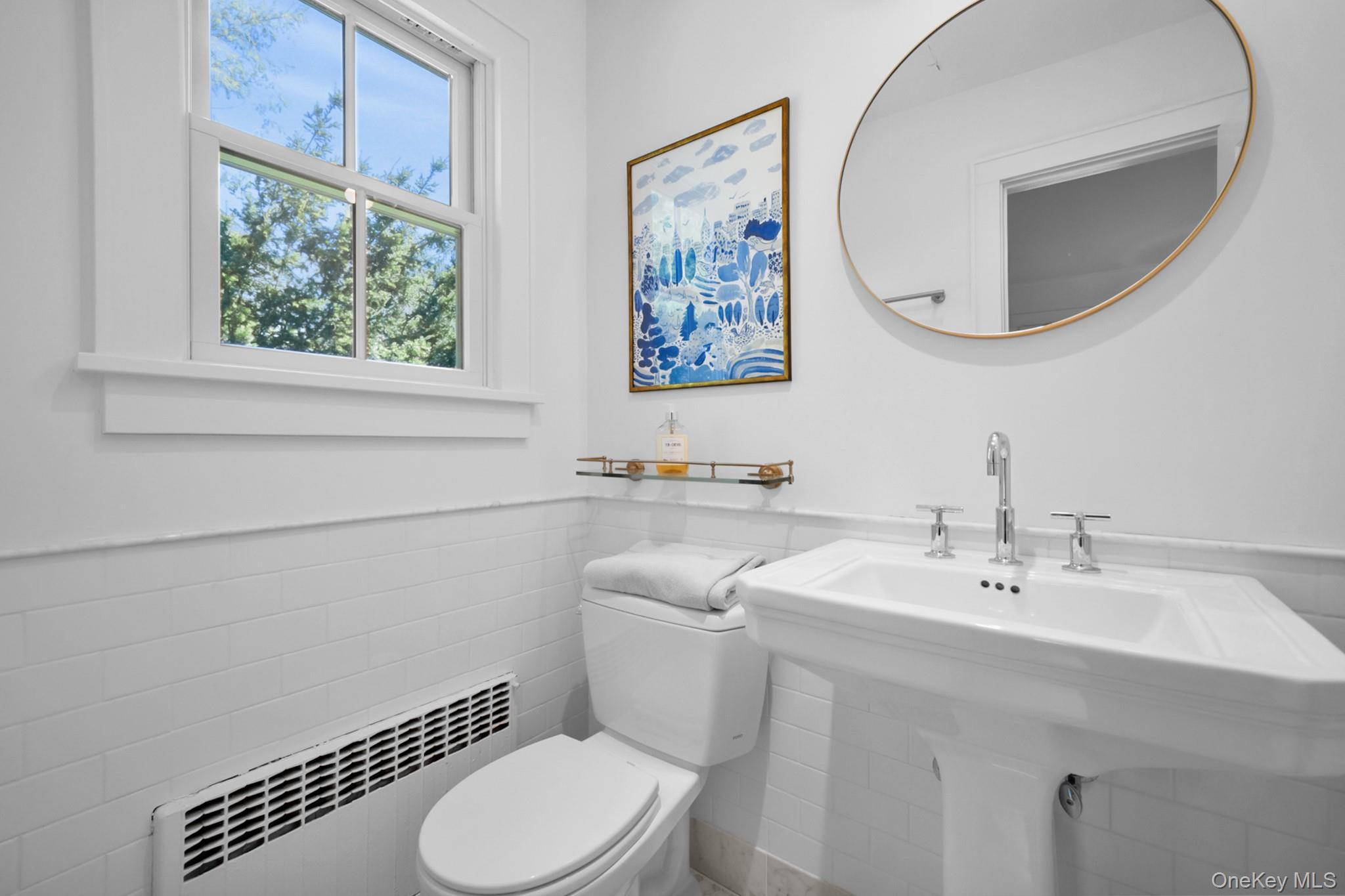 36 South Howells Point Road Bellport, NY 11713 - Photo 15 of 29 a bathroom with a toilet a sink and mirror