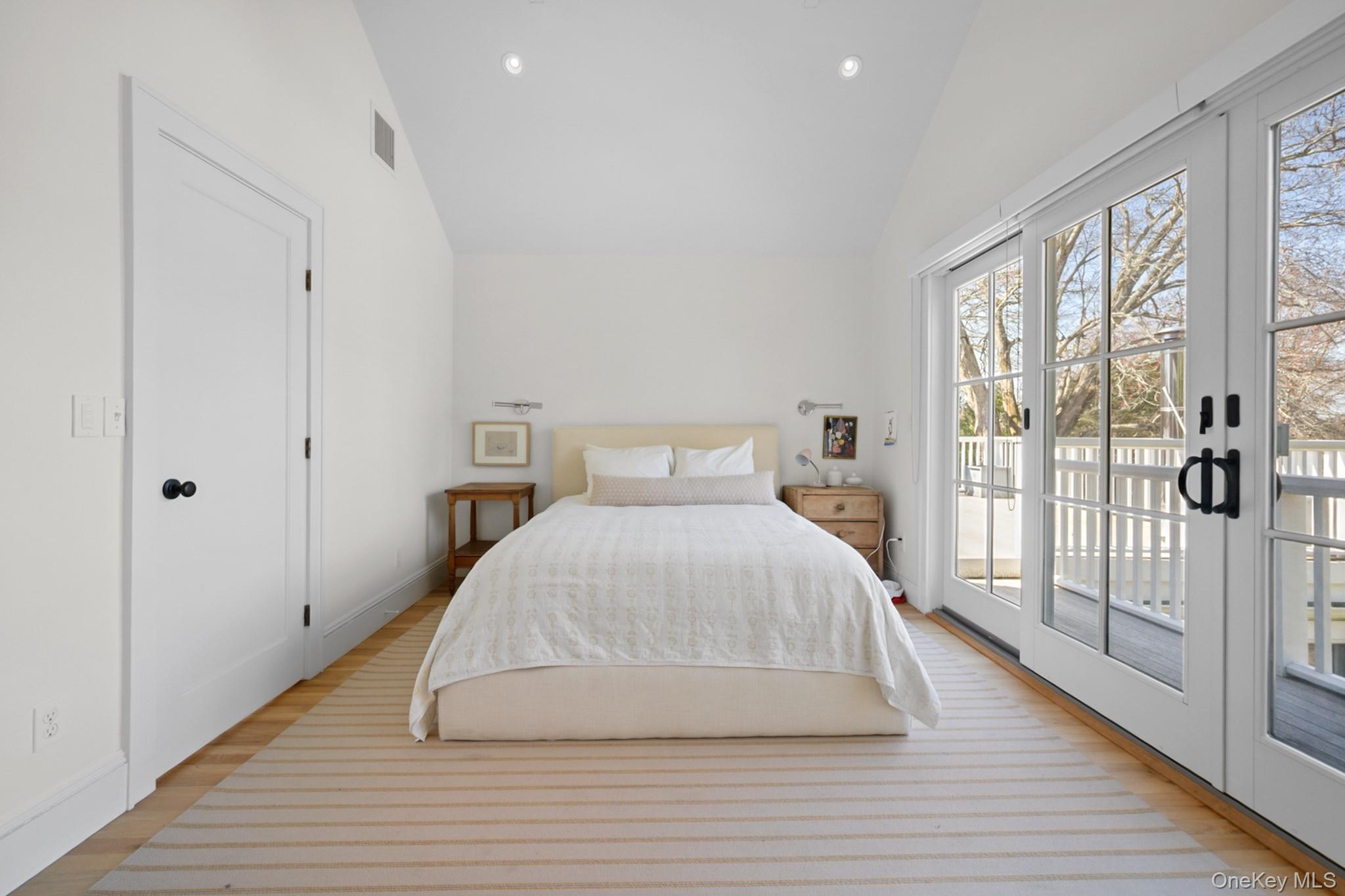 36 South Howells Point Road Bellport, NY 11713 - Photo 16 of 29 a bedroom with a bed and wooden floor