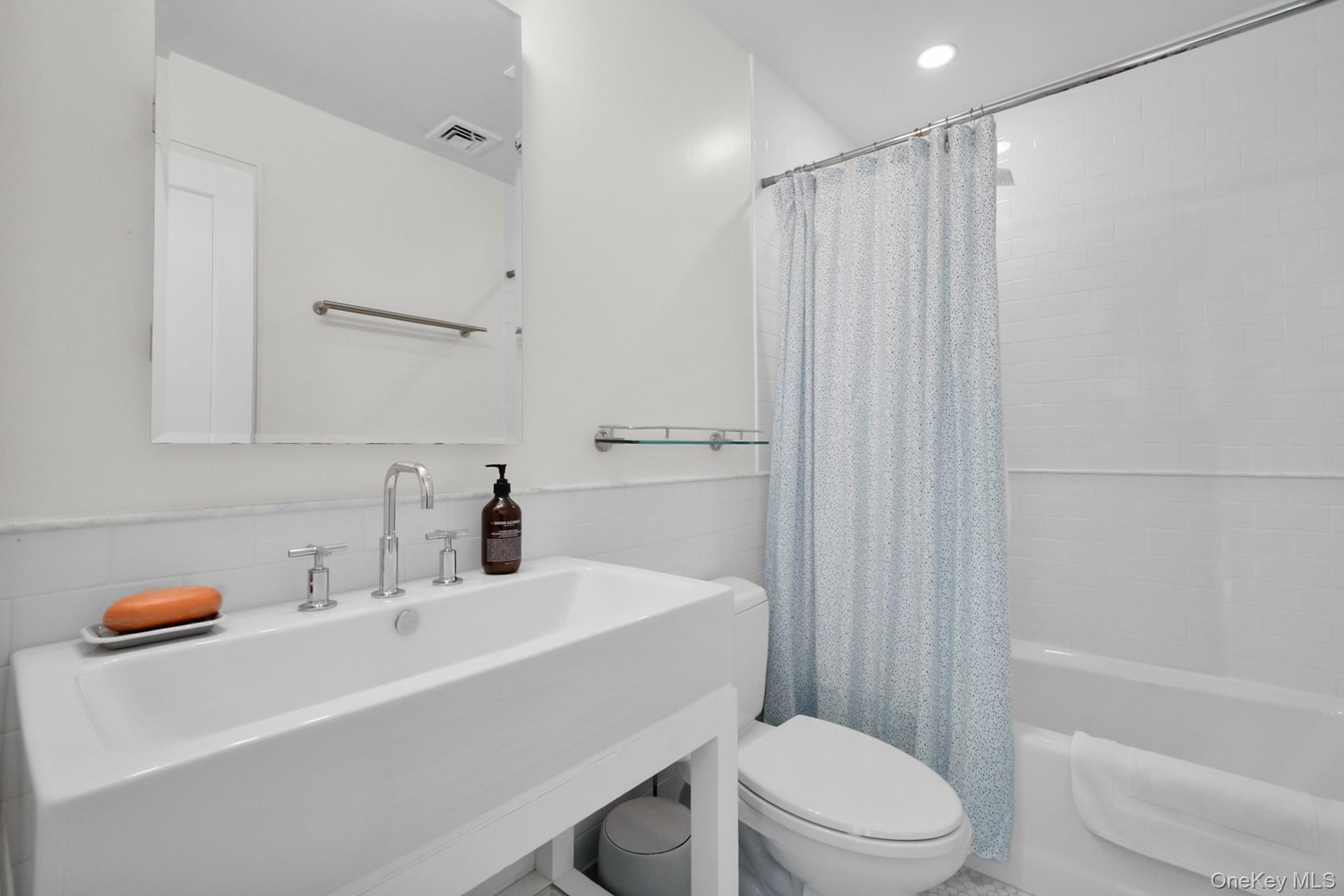 36 South Howells Point Road Bellport, NY 11713 - Photo 18 of 29 a bathroom with a sink a toilet and shower