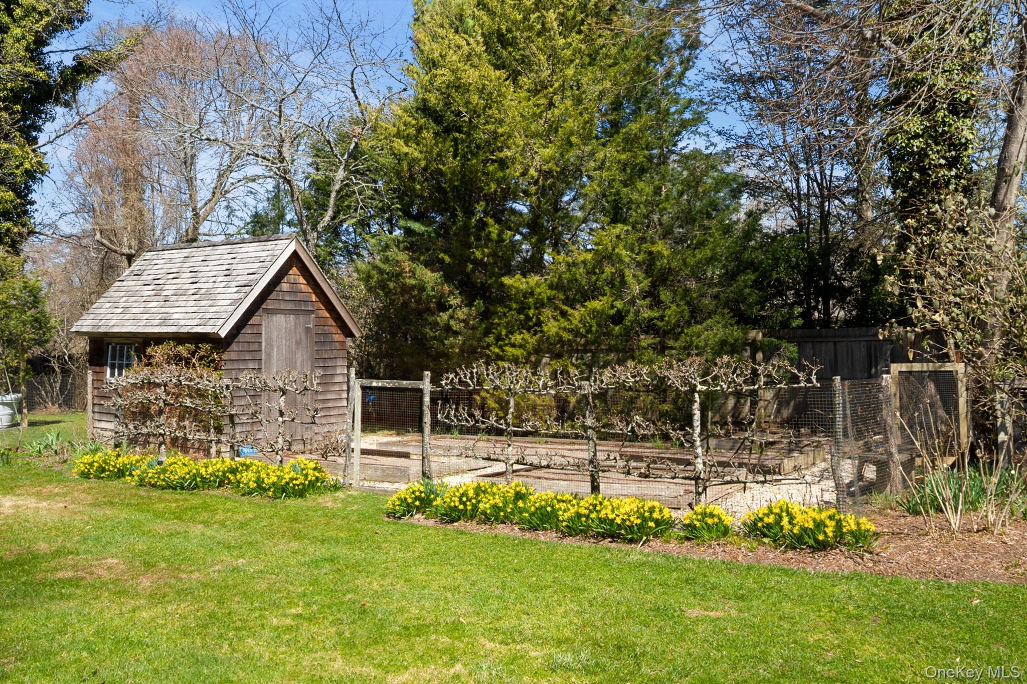 36 South Howells Point Road Bellport, NY 11713 - Photo 2 of 29 a front view of a house with a garden
