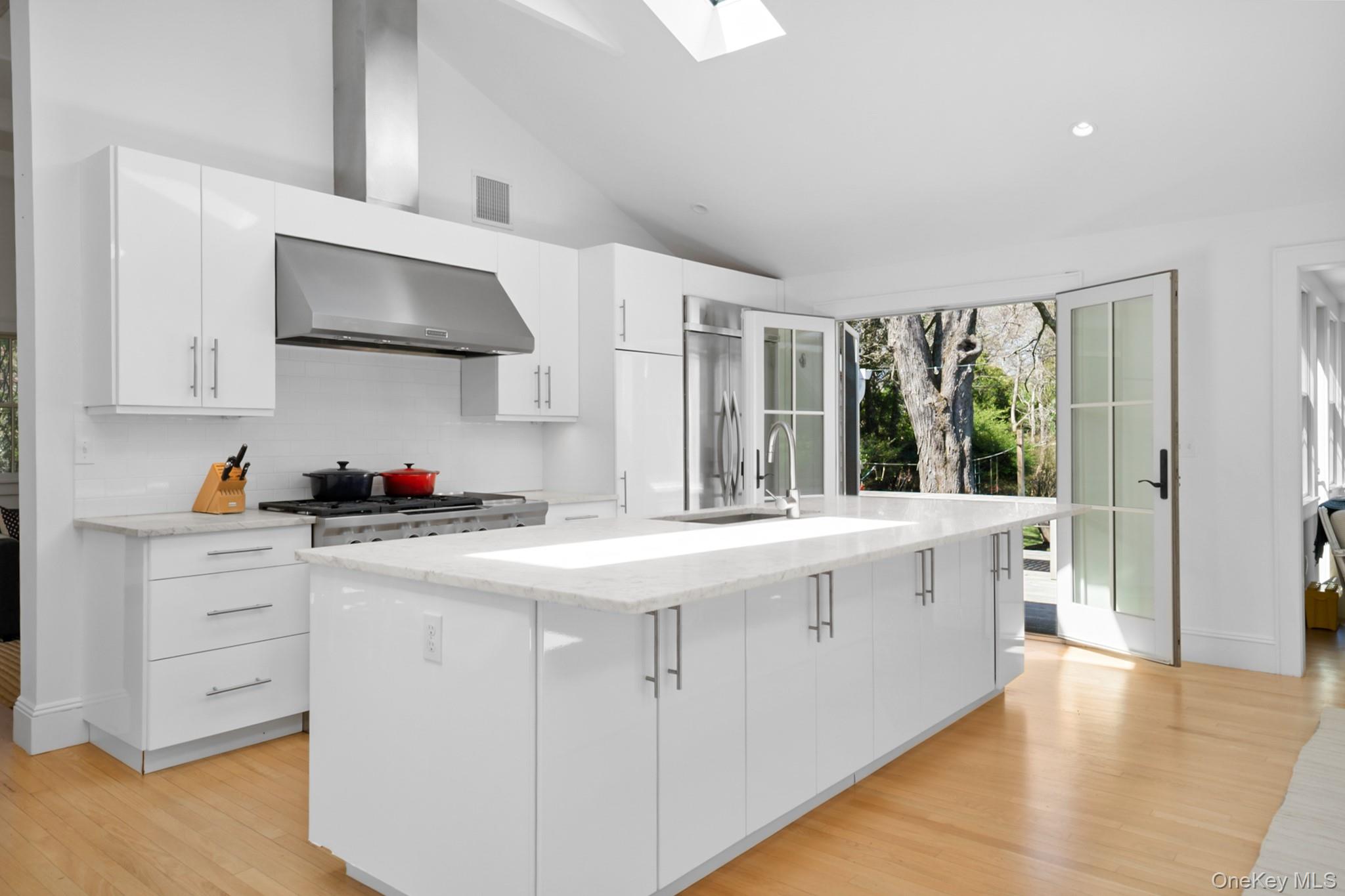 36 South Howells Point Road Bellport, NY 11713 - Photo 8 of 29 a kitchen with granite countertop a sink stainless steel appliances and cabinets