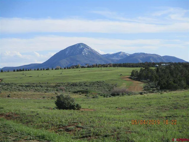 a view of mountain with outdoor and green space