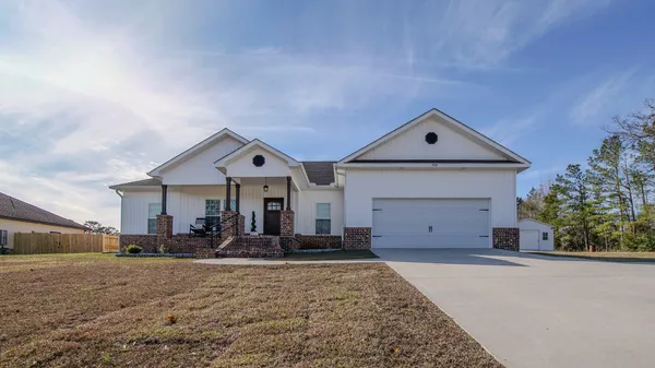 a front view of a house with a yard