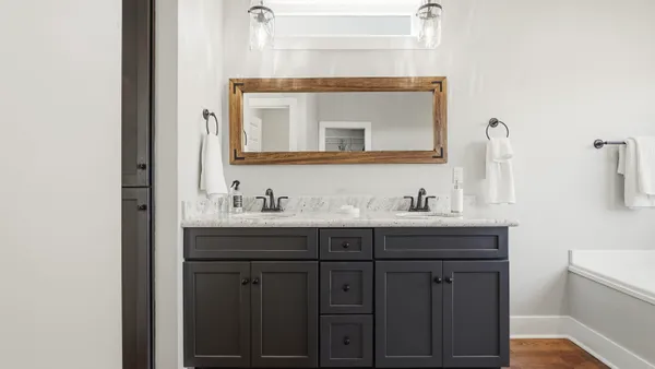 a bathroom with a sink vanity and mirror
