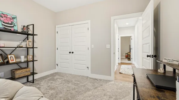 a view of a livingroom with furniture and a bedroom