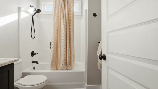 a bathroom with a toilet sink and shower