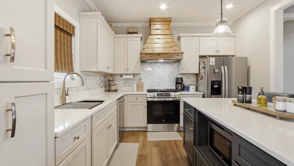 a kitchen with stainless steel appliances a sink stove and refrigerator