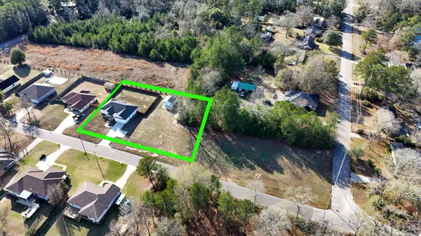 an aerial view of a house with a yard