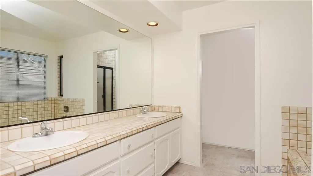 14662 Silverset Street Poway, CA 92064 - Photo 17 of 25 a bathroom with a granite countertop sink and a mirror