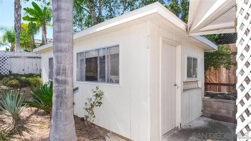 14662 Silverset Street Poway, CA 92064 - Photo 25 of 25 a view of a white house next to a yard with potted plants