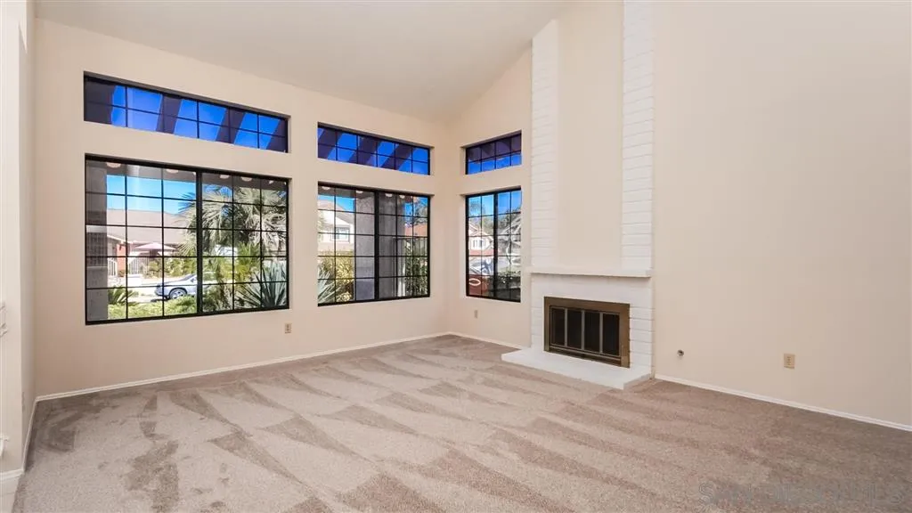 14662 Silverset Street Poway, CA 92064 - Photo 4 of 25 a view of an empty room with a fireplace and a window