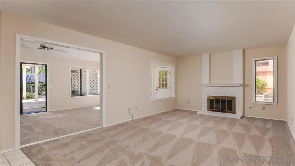 14662 Silverset Street Poway, CA 92064 - Photo 6 of 25 a view of livingroom with a fireplace cabinet and windows