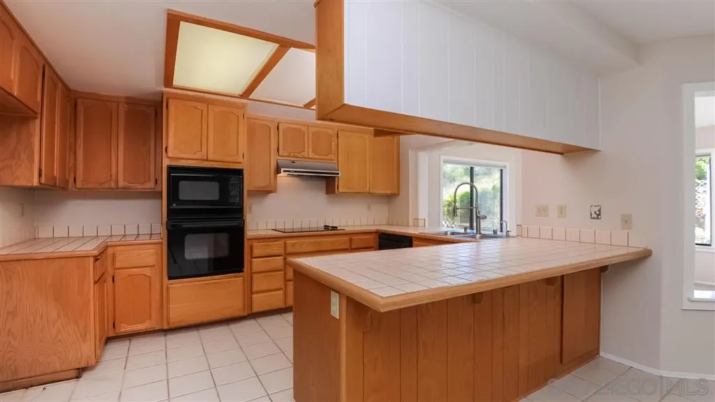 14662 Silverset Street Poway, CA 92064 - Photo 7 of 25 a kitchen with granite countertop a sink and a stove